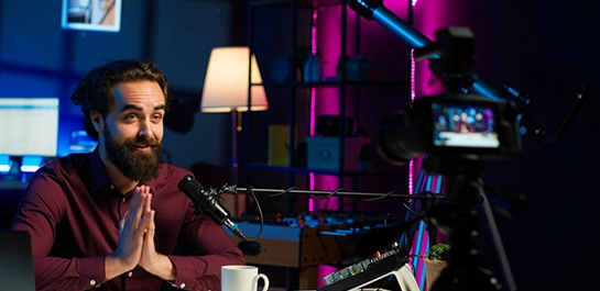 A content creator films a segment in a studio, a key part of executing a video marketing strategy.